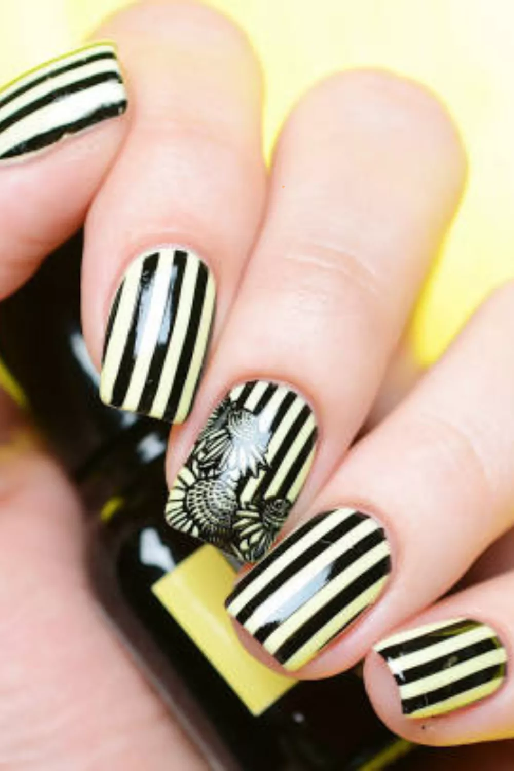 Striped and floral nail art with black and white