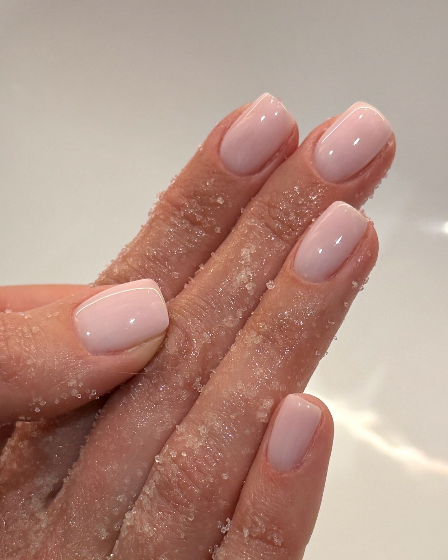 Short nails with glossy pink polish