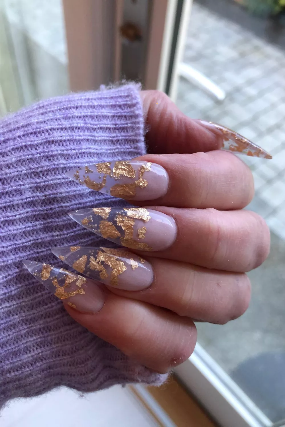 Stiletto nails with gold leaf decoration