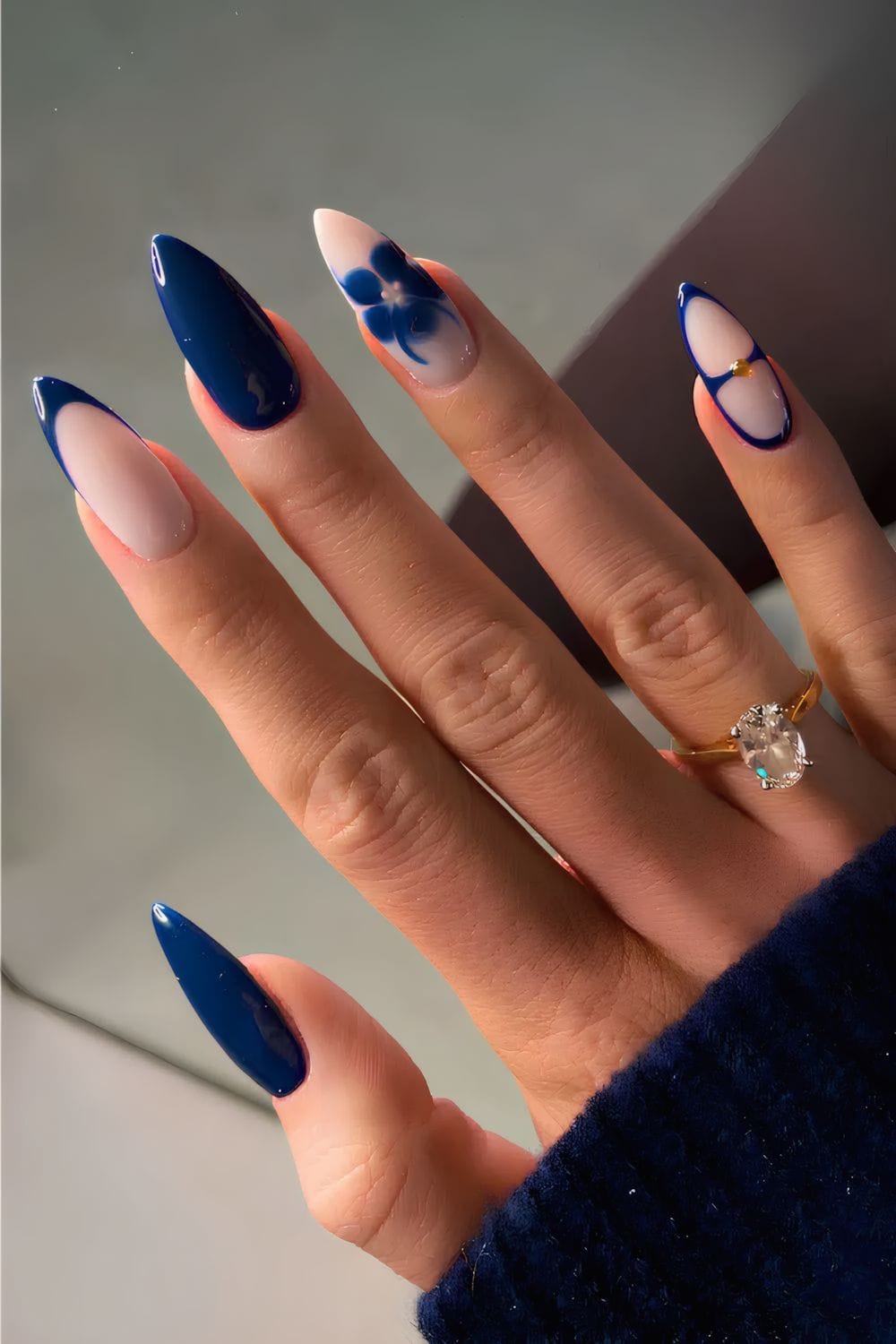 Glossy navy nails with floral and geometric design, artistic and bold.