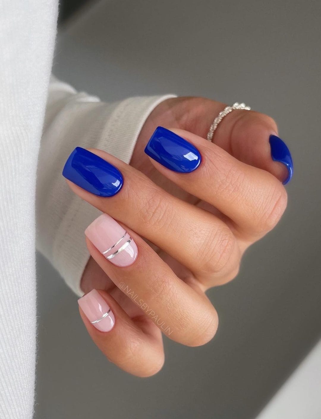 Navy and pink nails with metallic stripes, bold and modern.