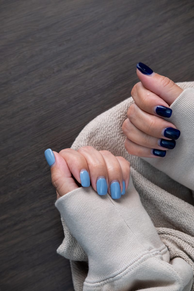 Dual-toned navy and light blue nails, sophisticated and stylish.