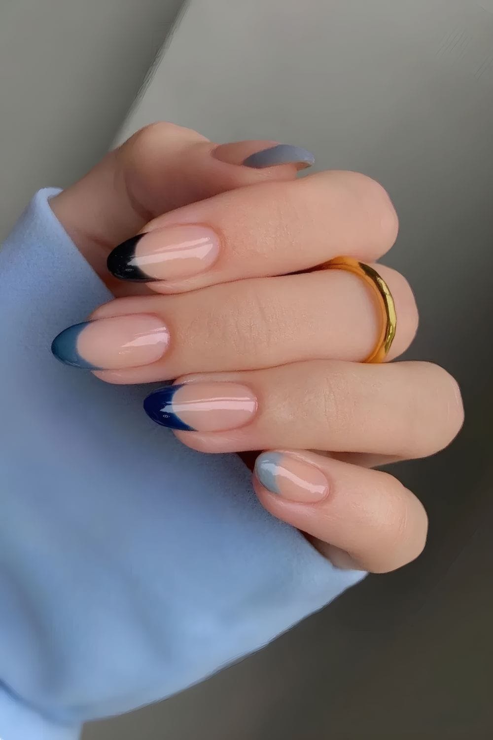 Ombre navy nails with nude base, artistic and modern.