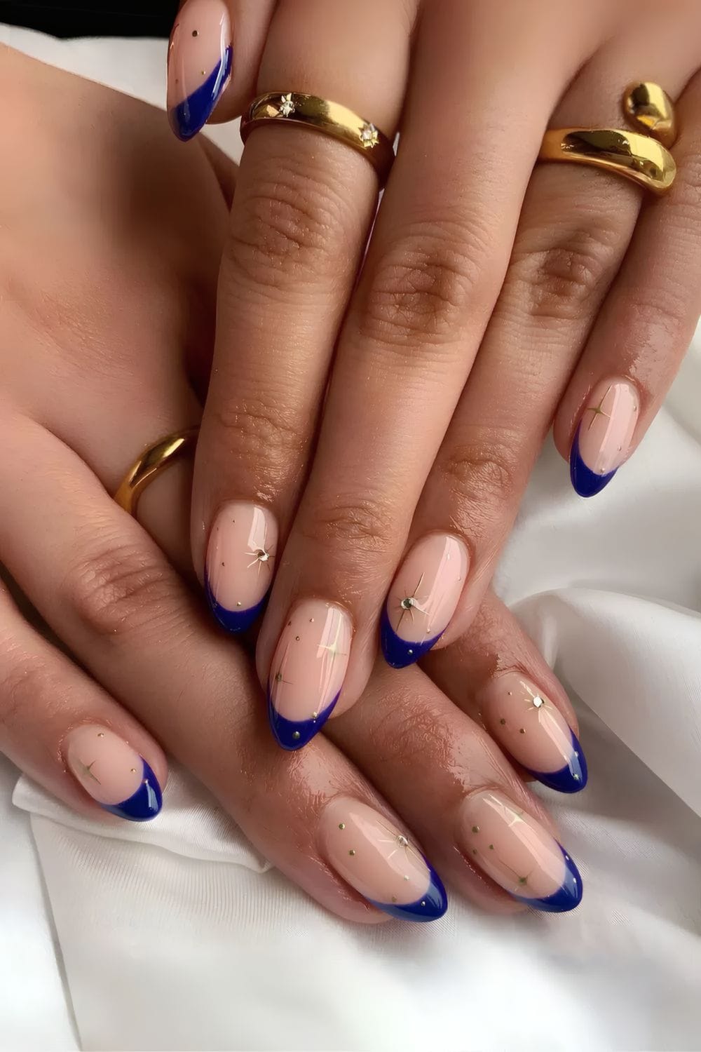Navy French tips with star accents, elegant and celestial.