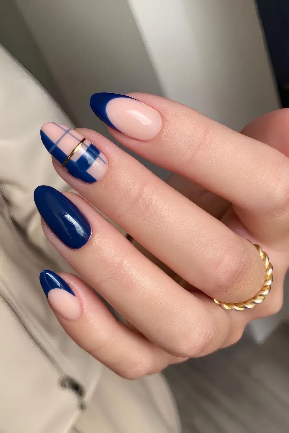 Navy and nude nails with plaid accent, stylish and unique.