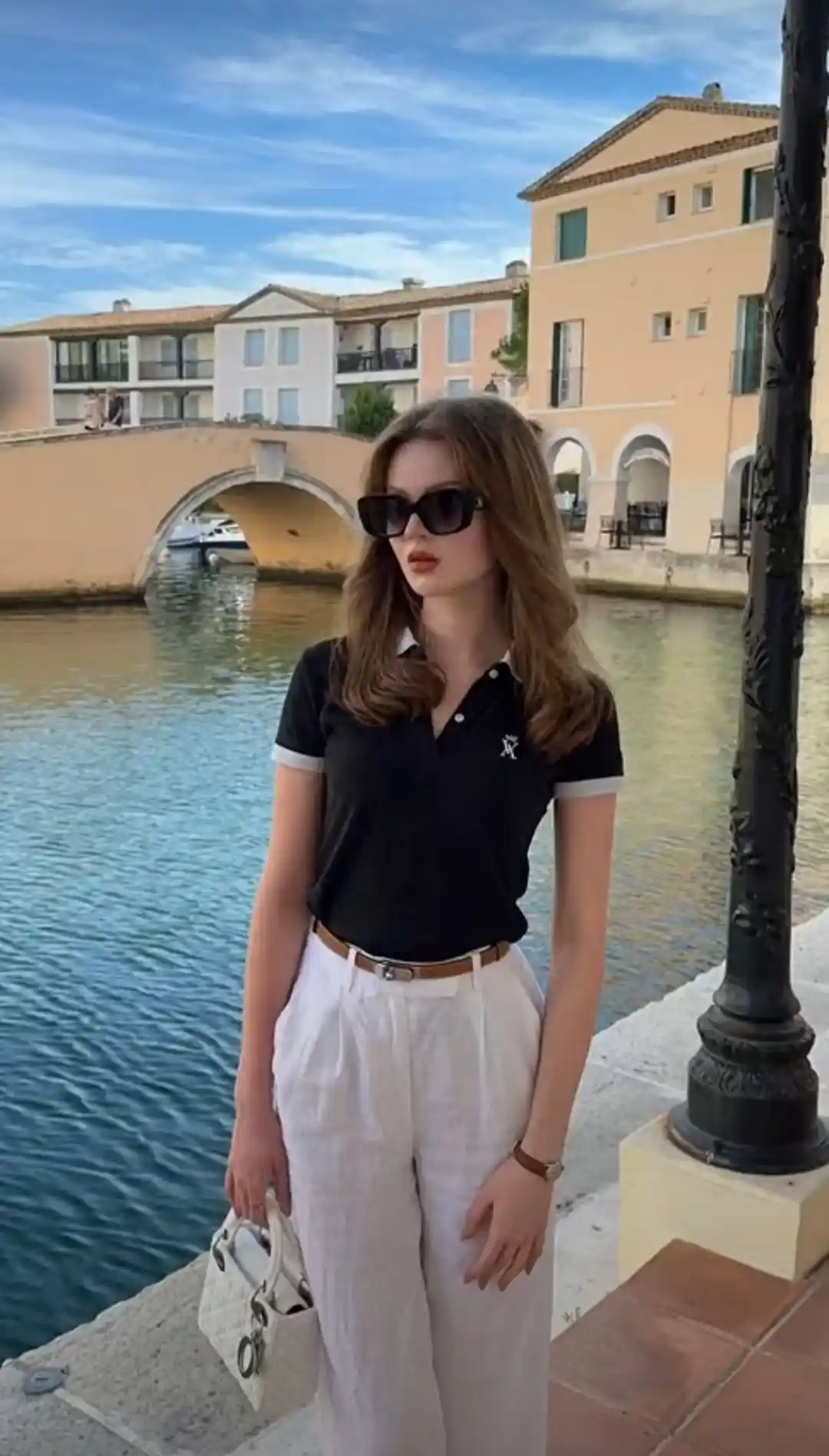 Black polo with white linen pants for relaxed summer style