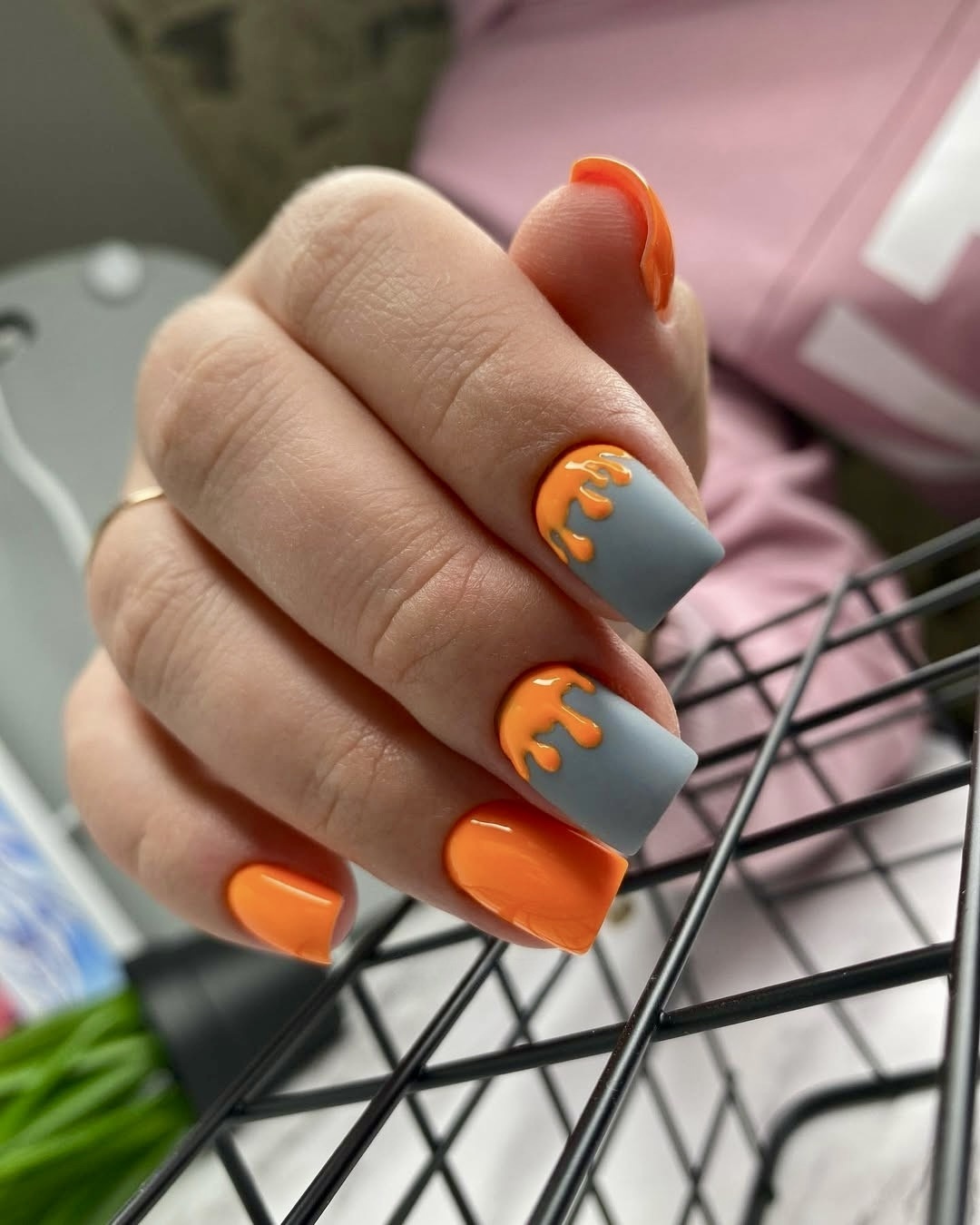 Orange and gray nails with drip art design