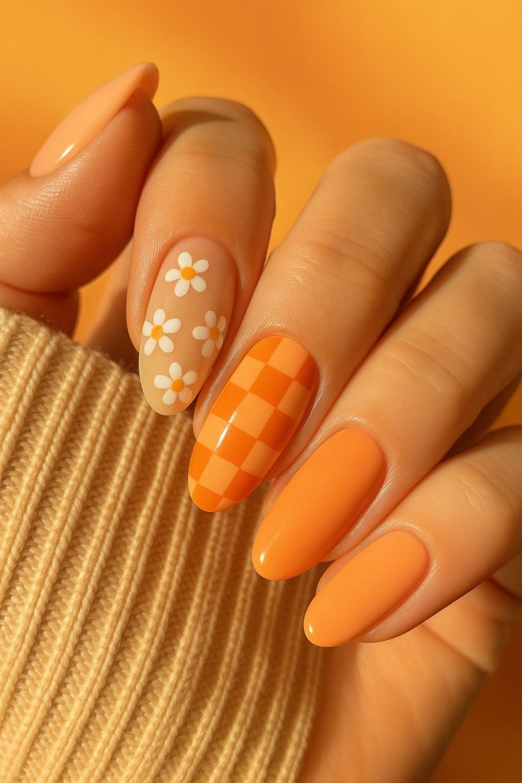 Orange nails with floral and checkerboard design