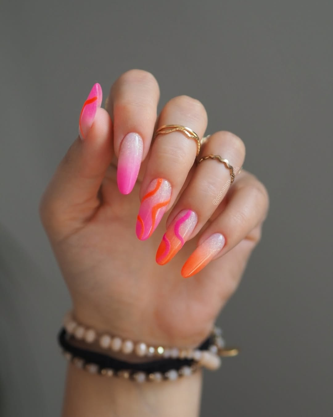 Neon orange and pink nails with flame design