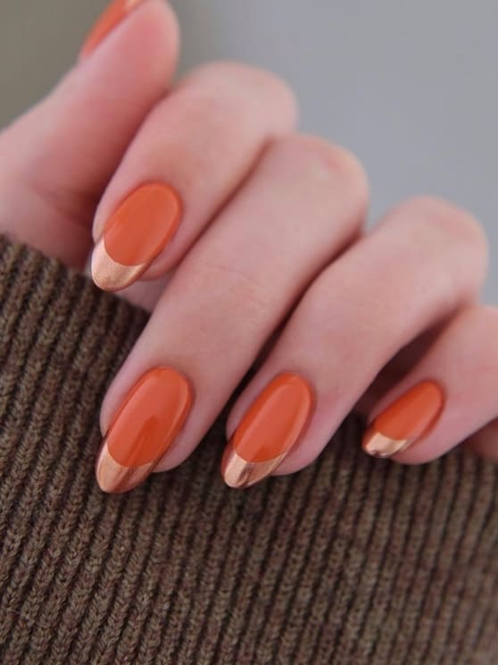 Orange nails with copper French tips