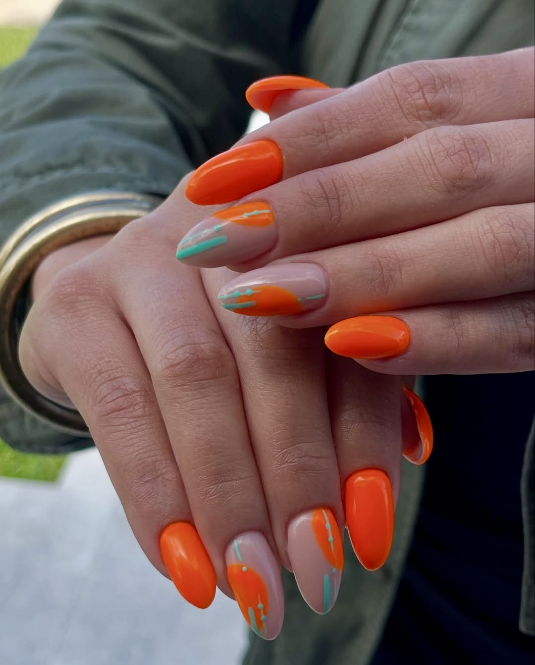 Orange nails with artistic drip design