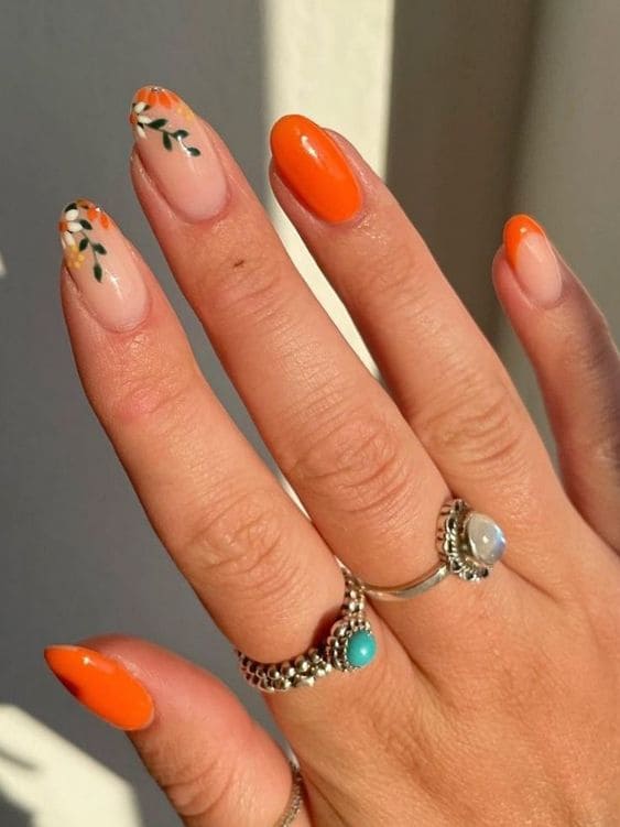 Orange French tips with floral details