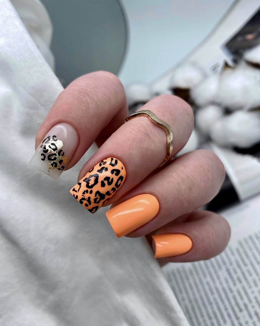 Orange nails with leopard print design
