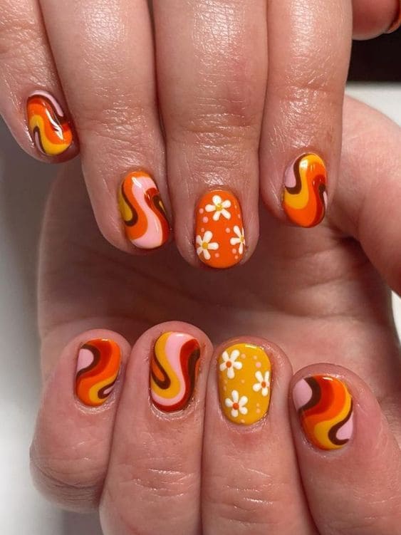 Retro orange swirl nails with daisies