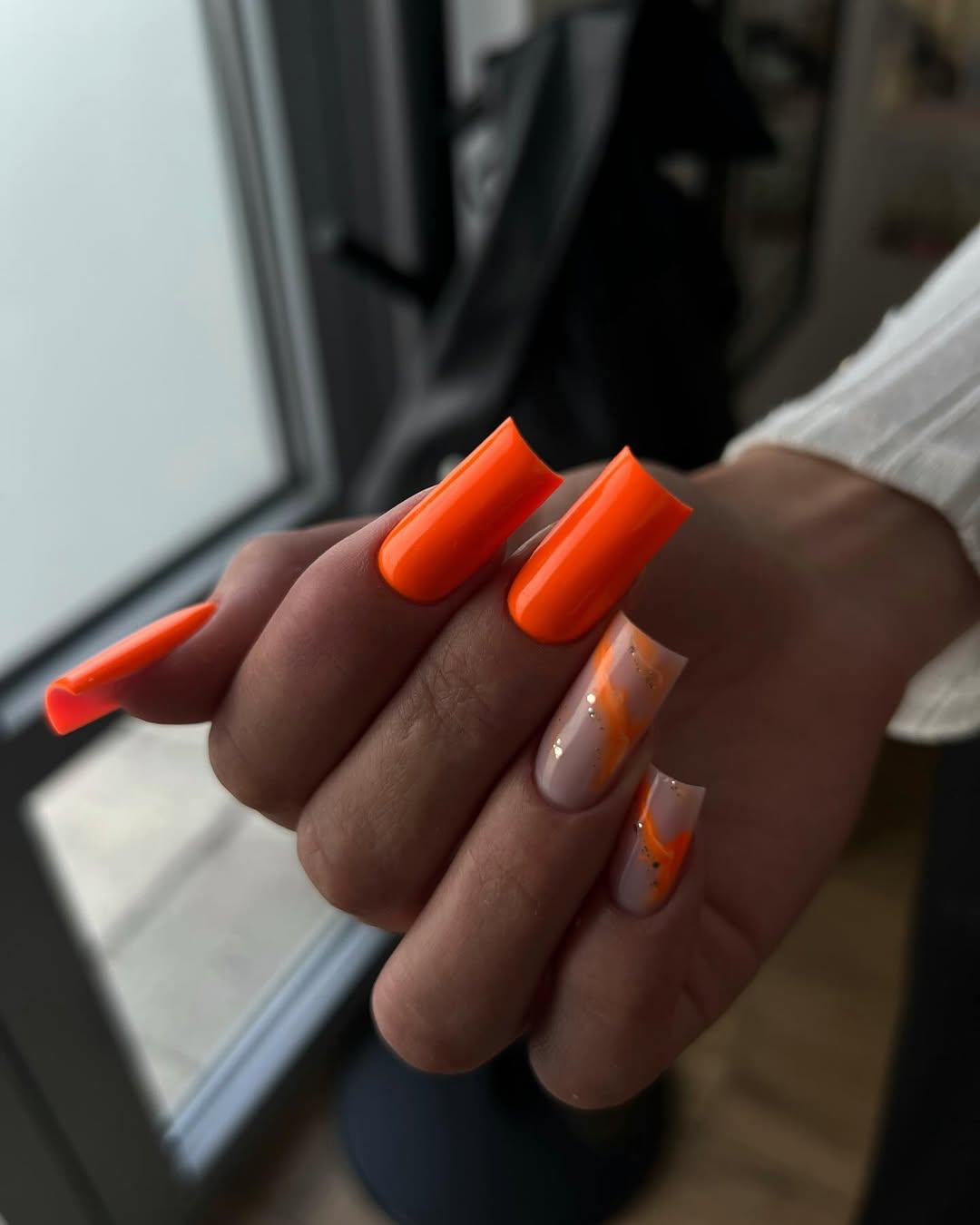 Bright orange coffin nails with neutral accents