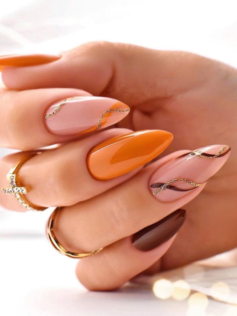 Orange and nude nails with gold filigree