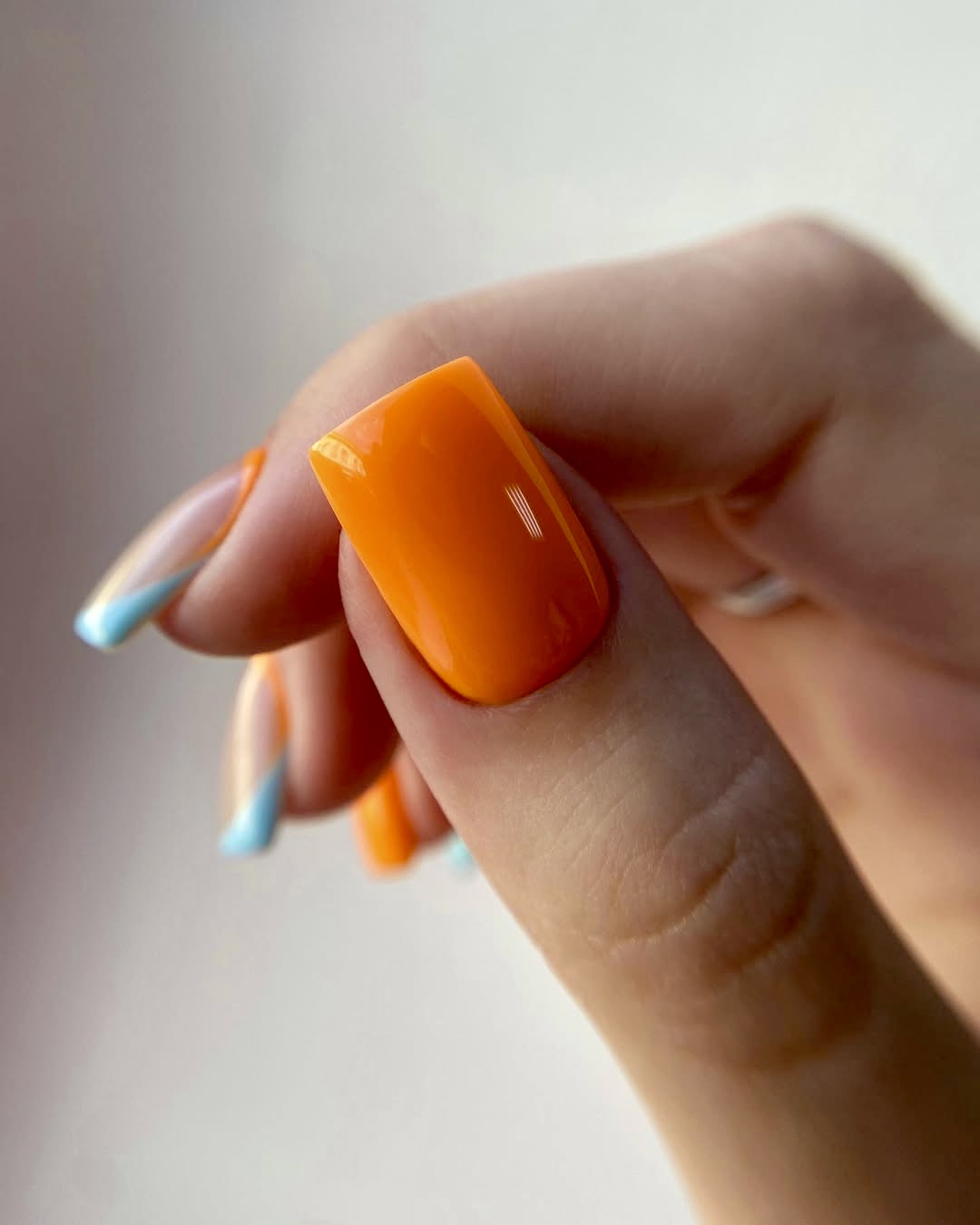 Orange nails with blue French tips