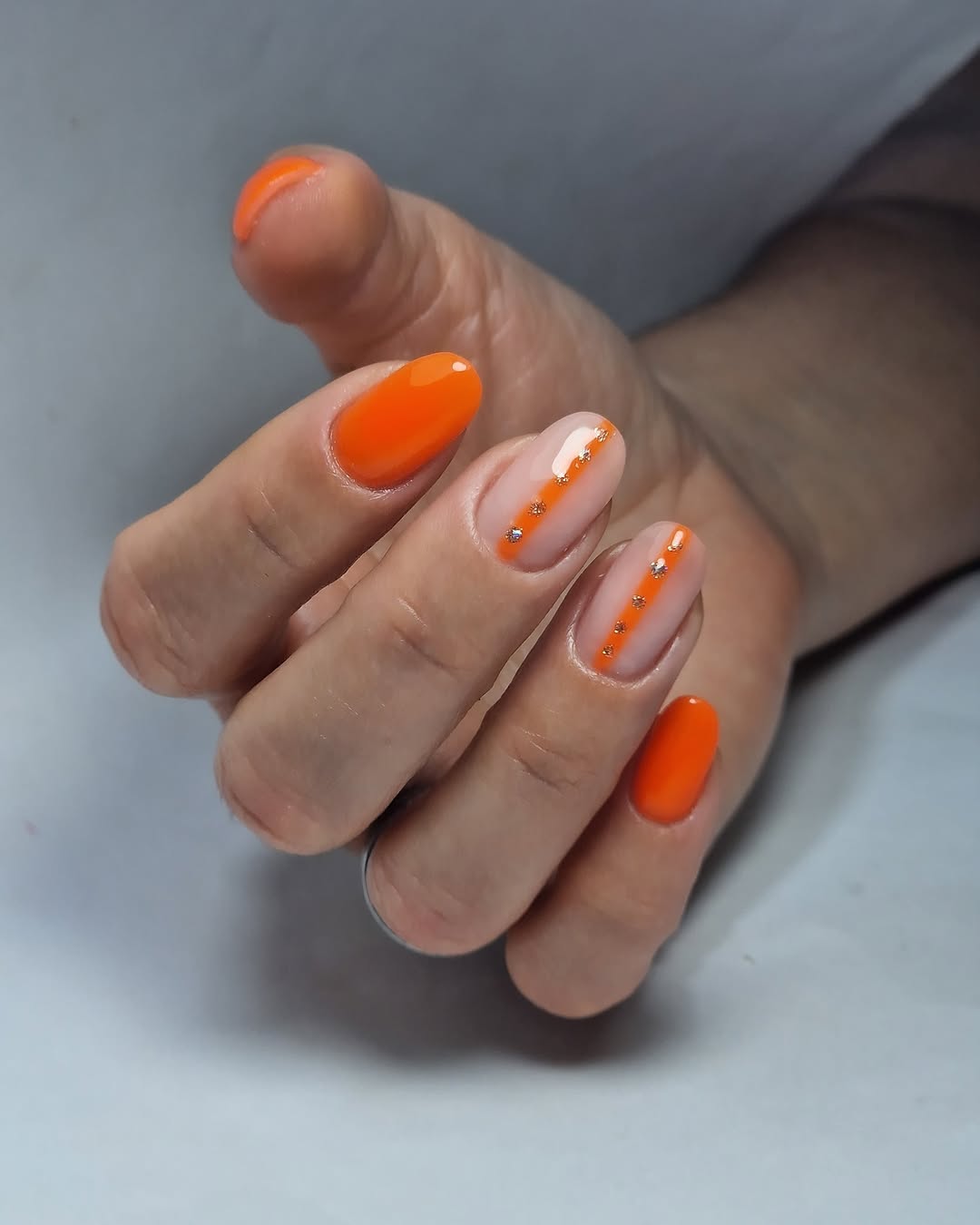 Orange nails with delicate beads