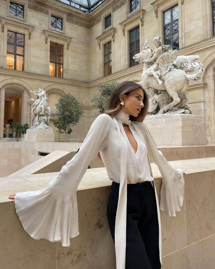 Flared sleeve blouse with black trousers