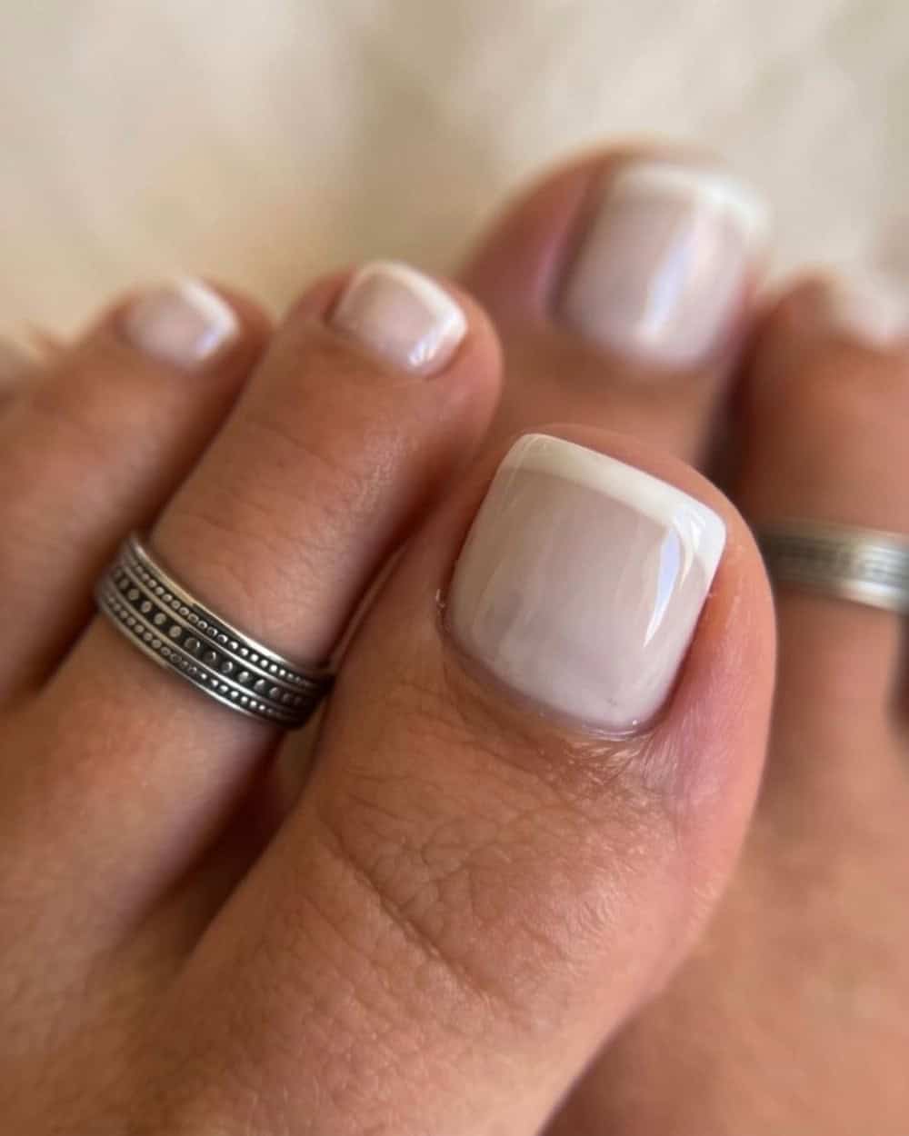 Soft white pedicure with a glossy finish