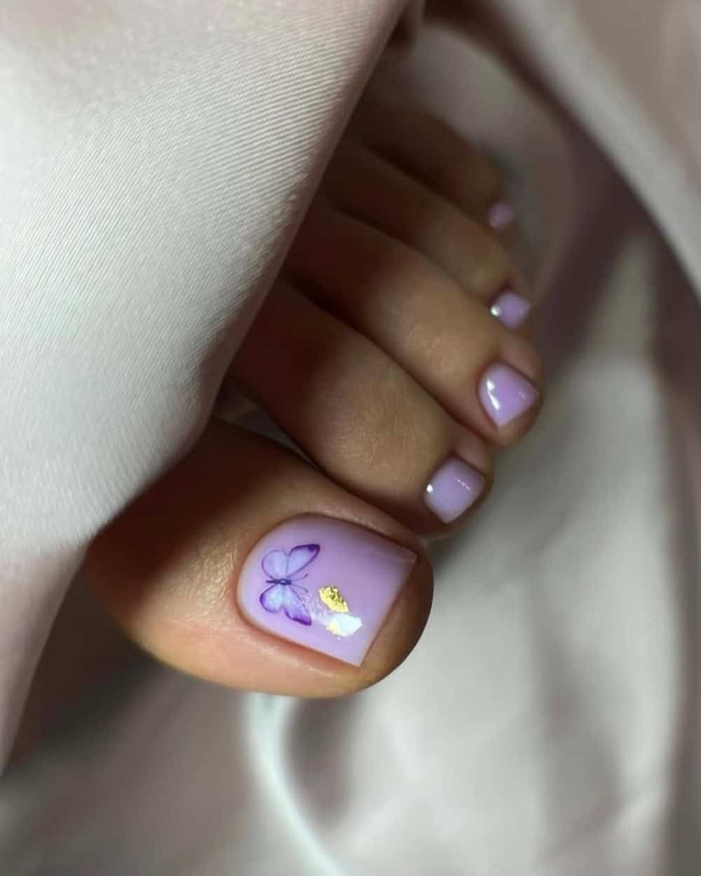 Lavender pedicure with butterfly nail art