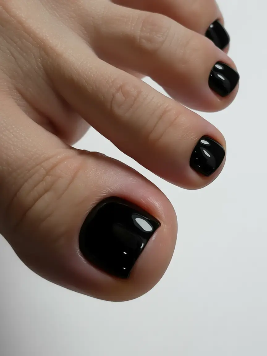 Glossy black pedicure on short nails