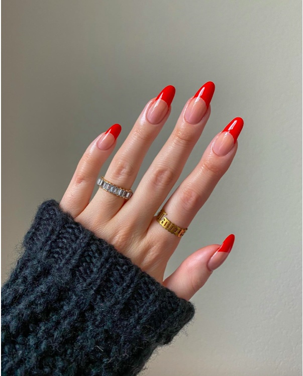 Minimal red French tips on almond nails