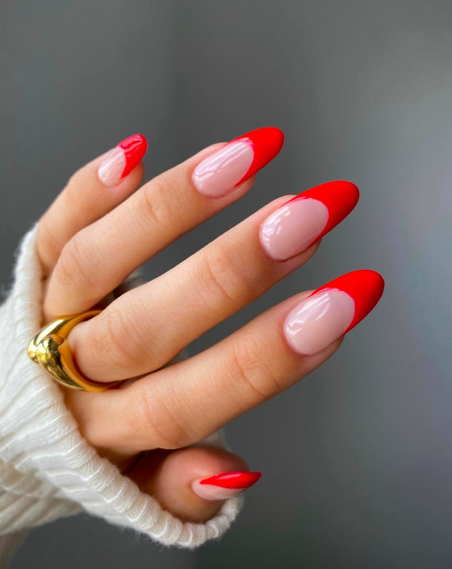 Bright red tips on nude almond nails