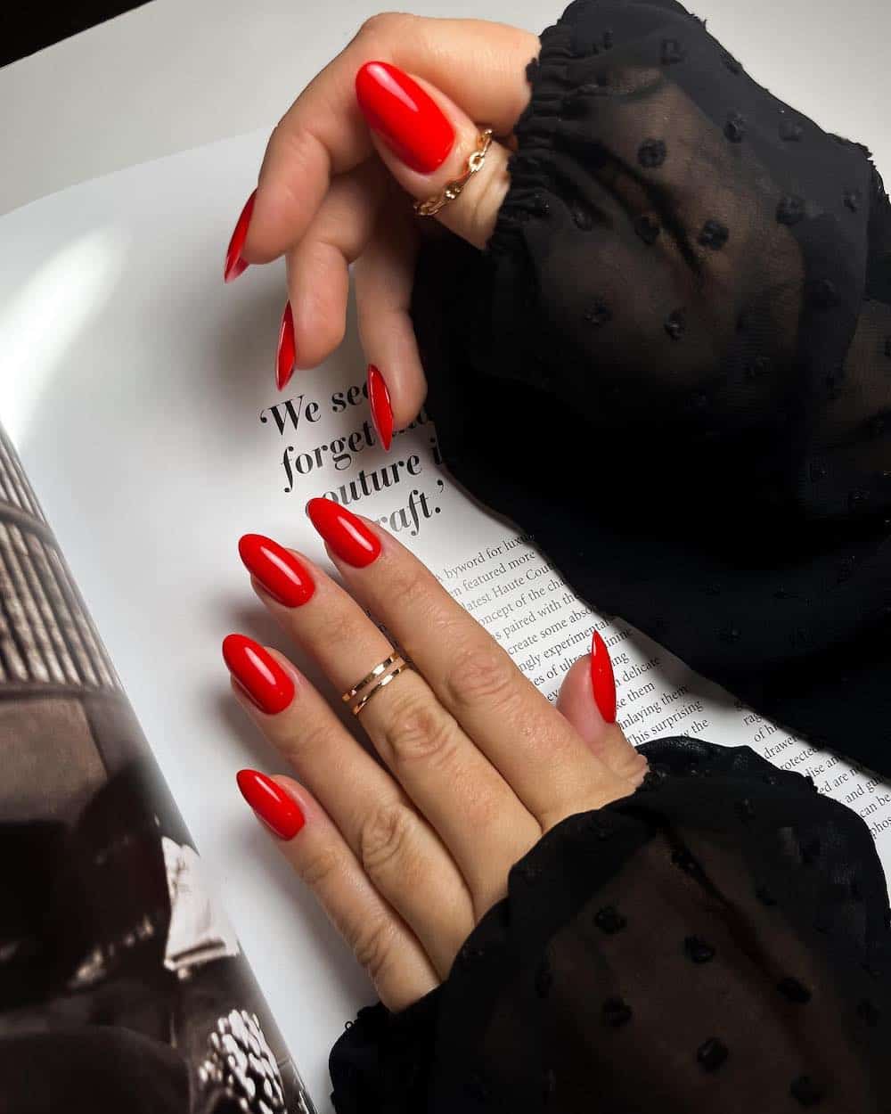 Bright red almond nails with rings