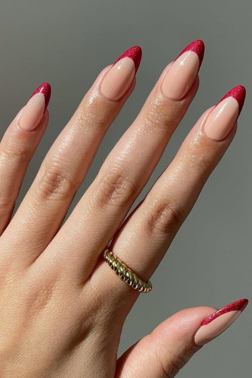 Red glitter French tips on nude nails
