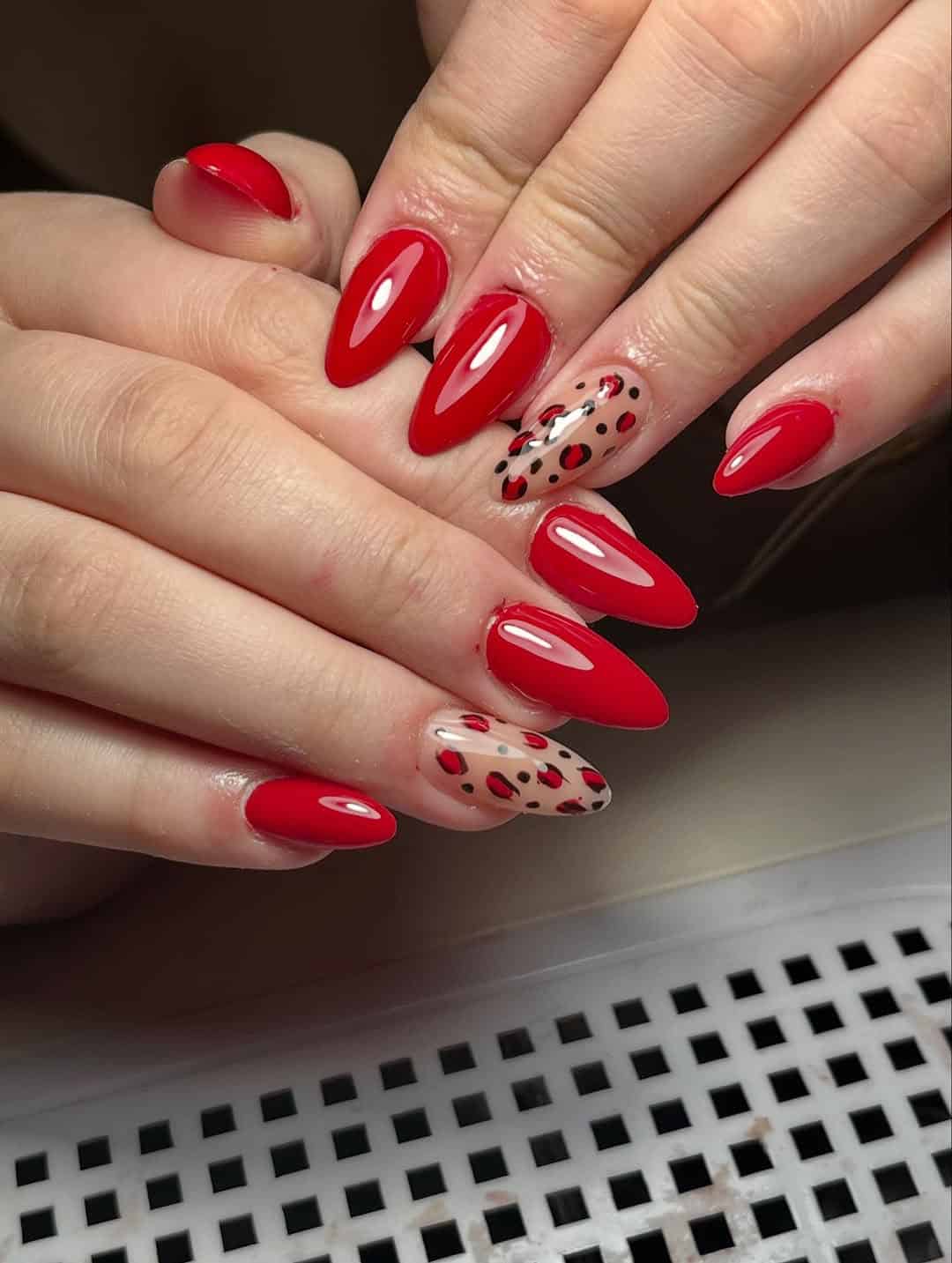 Red nails with leopard accent nail