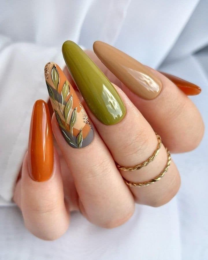 Long almond nails in brown and olive with leaf design