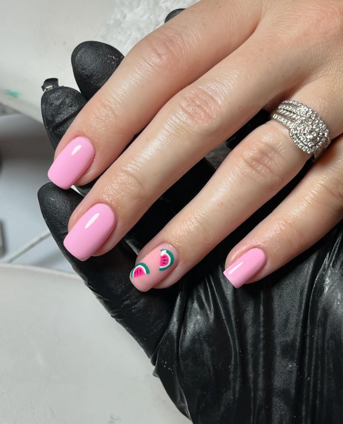 Pink nails with watermelon accent design