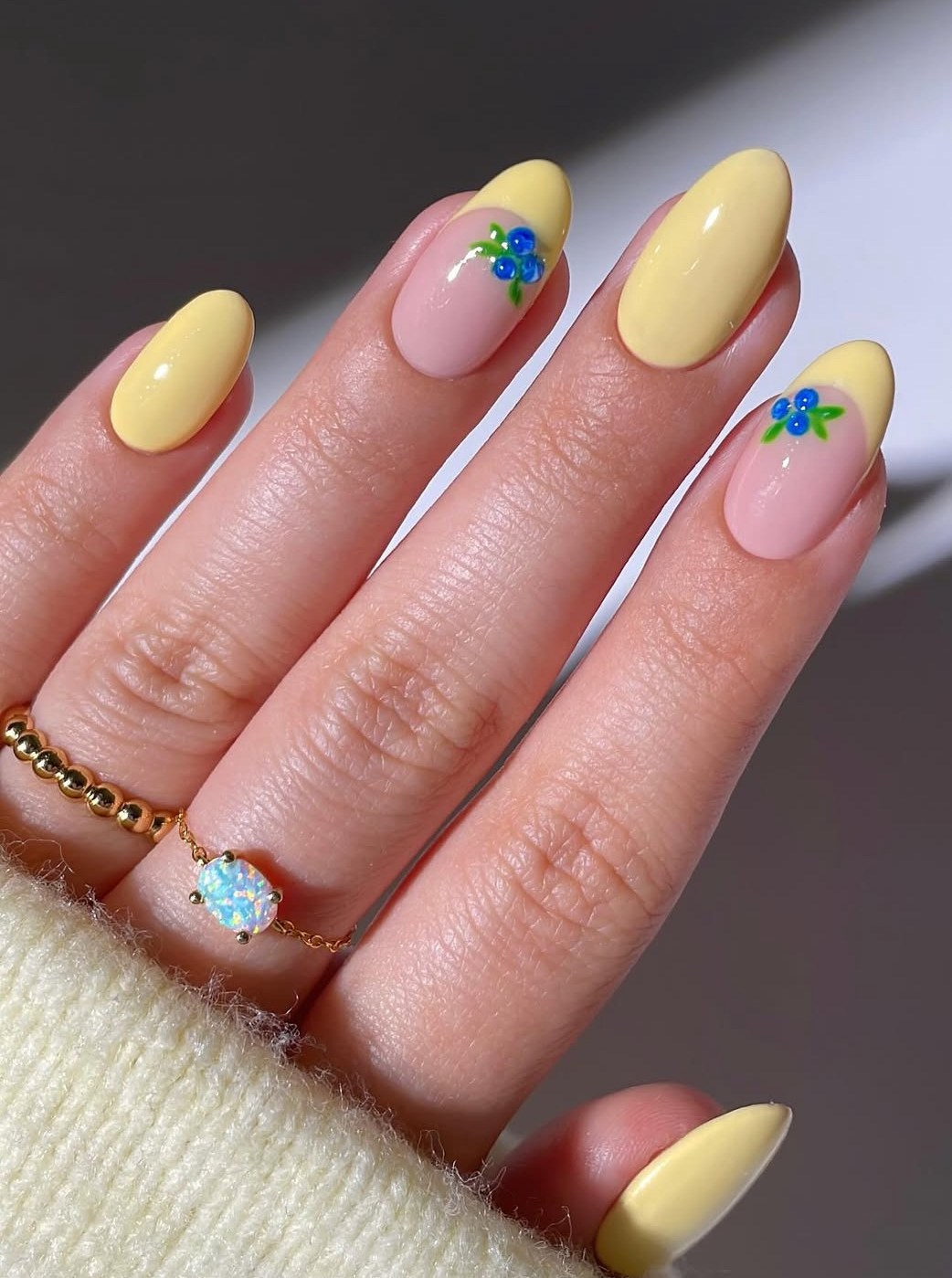 Yellow and nude nails with blue floral accents