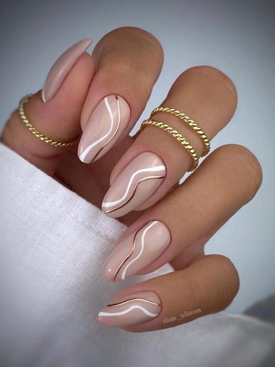 Nude almond nails with white wavy lines