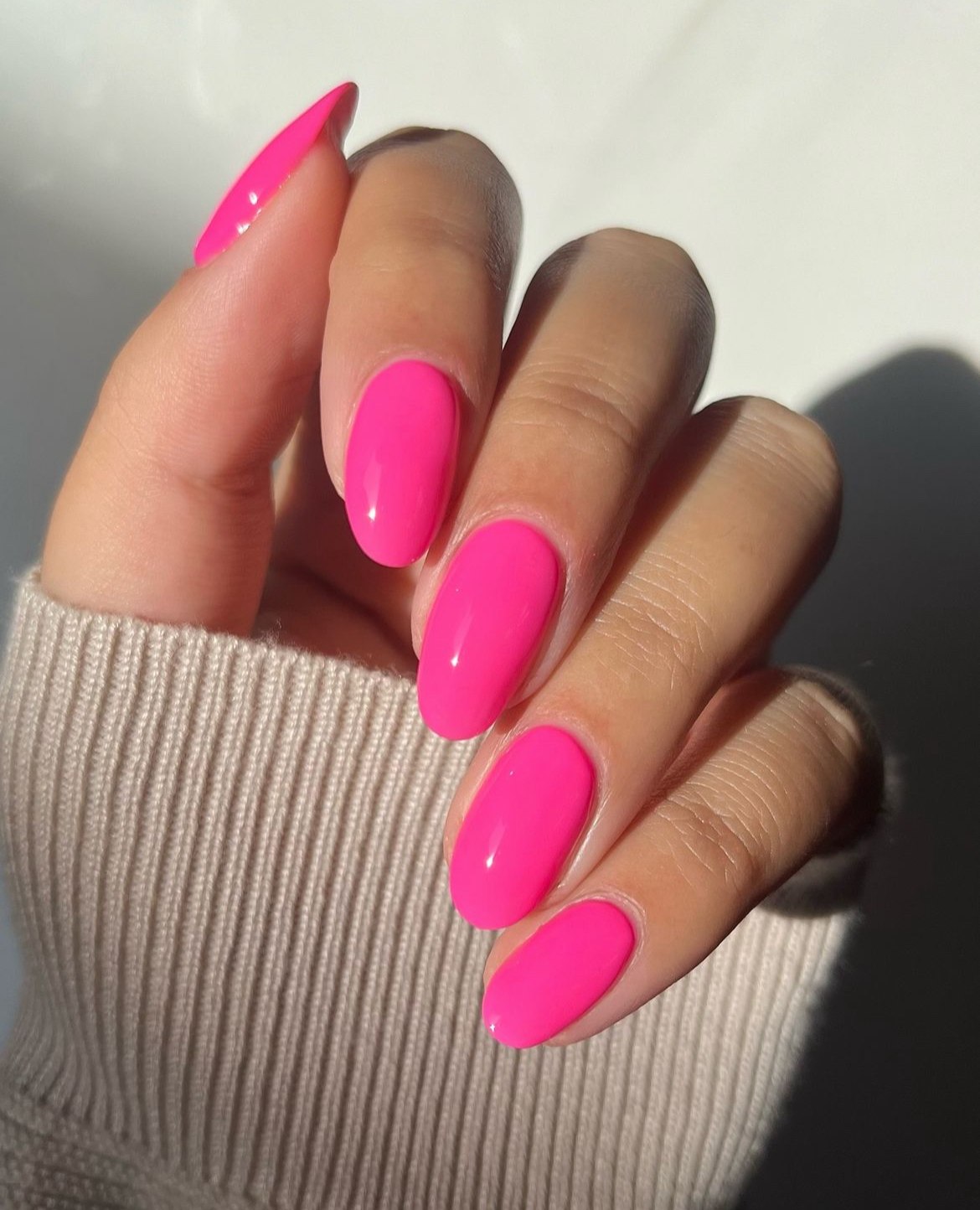 Almond nails in vibrant pink with glossy finish