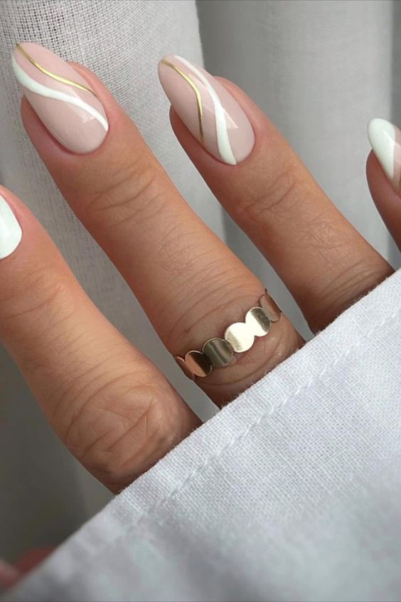 Almond nails with white and gold wave design