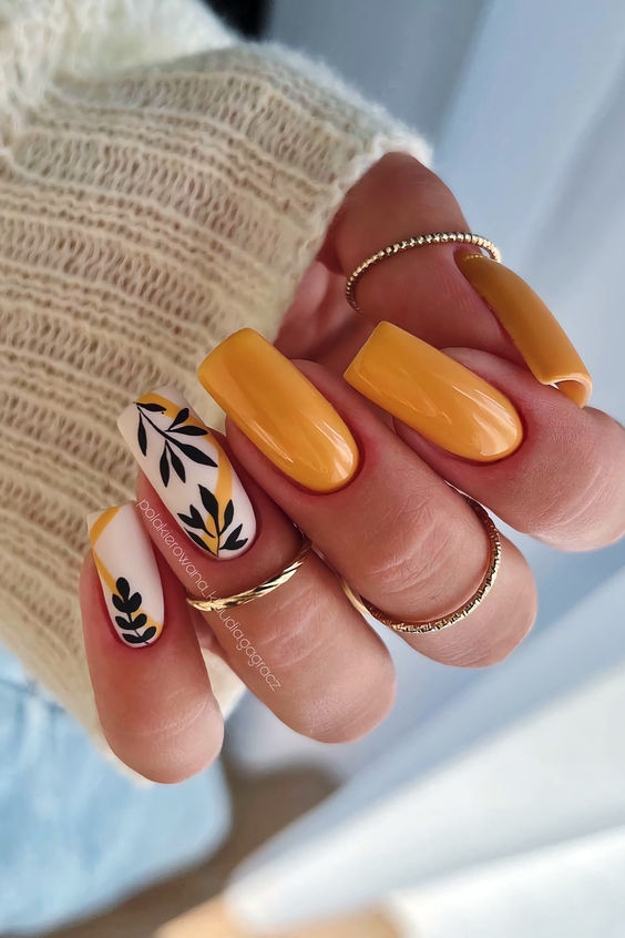 Yellow long nails with floral accent
