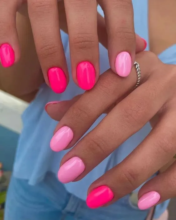 Dual-tone pink nails, vibrant and lively, a Pinterest favorite for bold style statements.