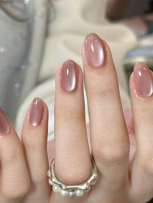 Pearl sheen short almond nails, elegant and refined.