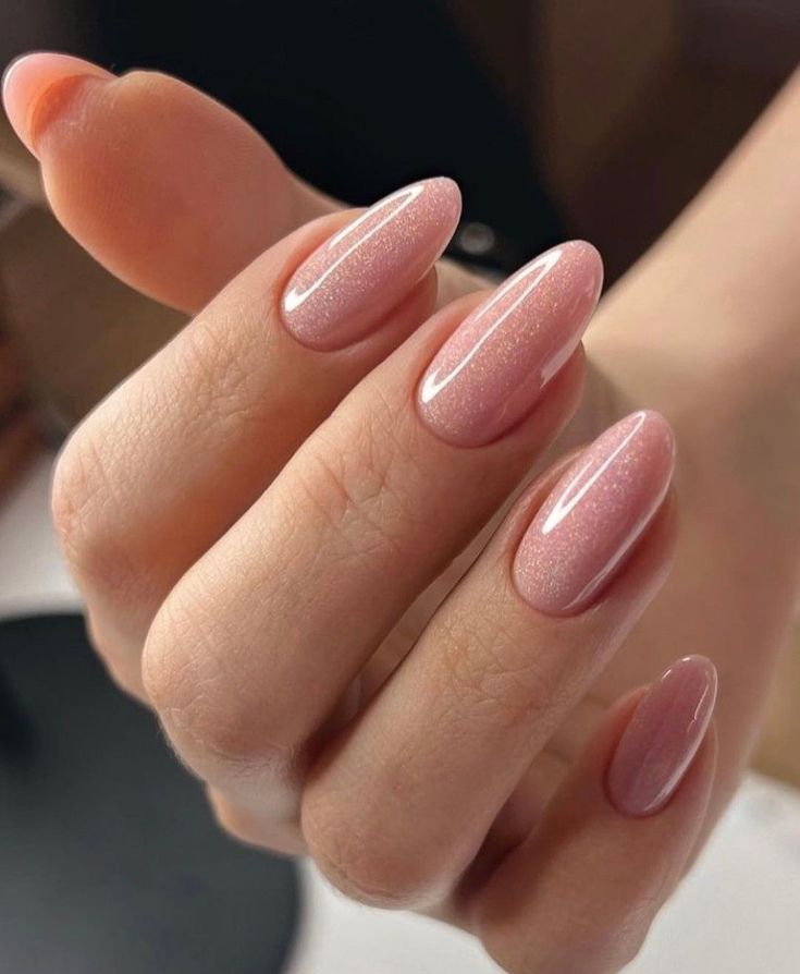 Glossy pink almond nails, sophisticated and chic.