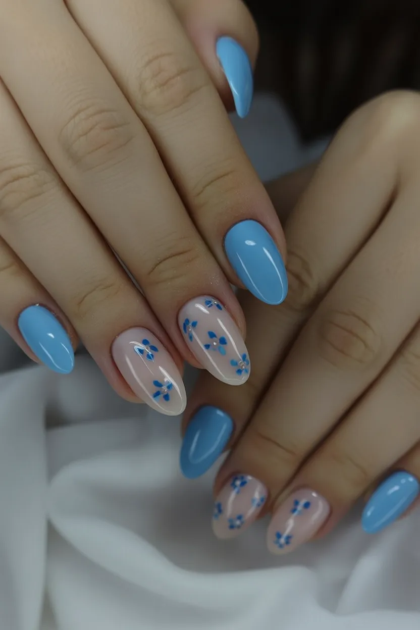Blue nails with floral accents, fresh and lively.