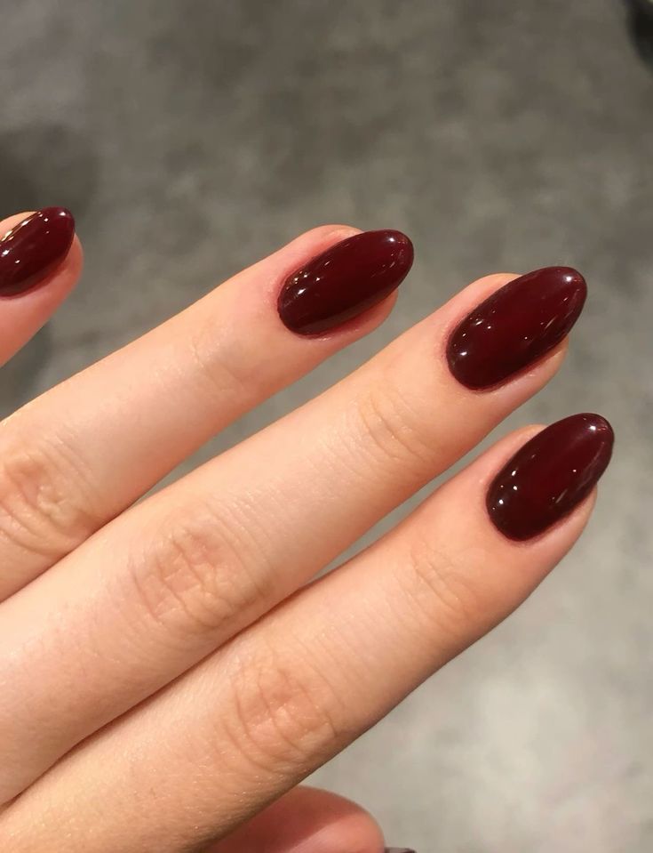 Deep burgundy almond nails, rich and luxurious.