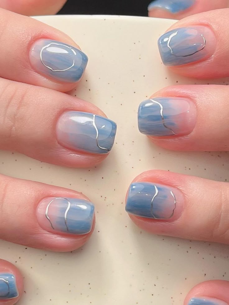 Dreamy blue cloud short gel nails with silver accents