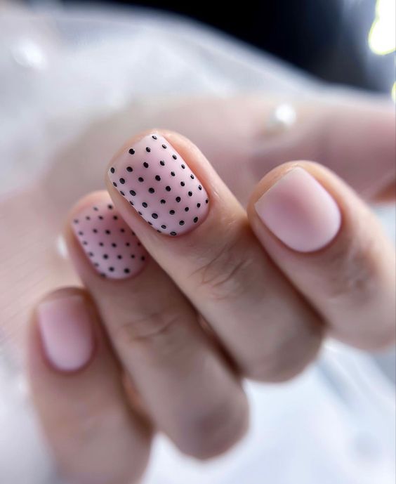 Matte pink short gel nails with black polka dots