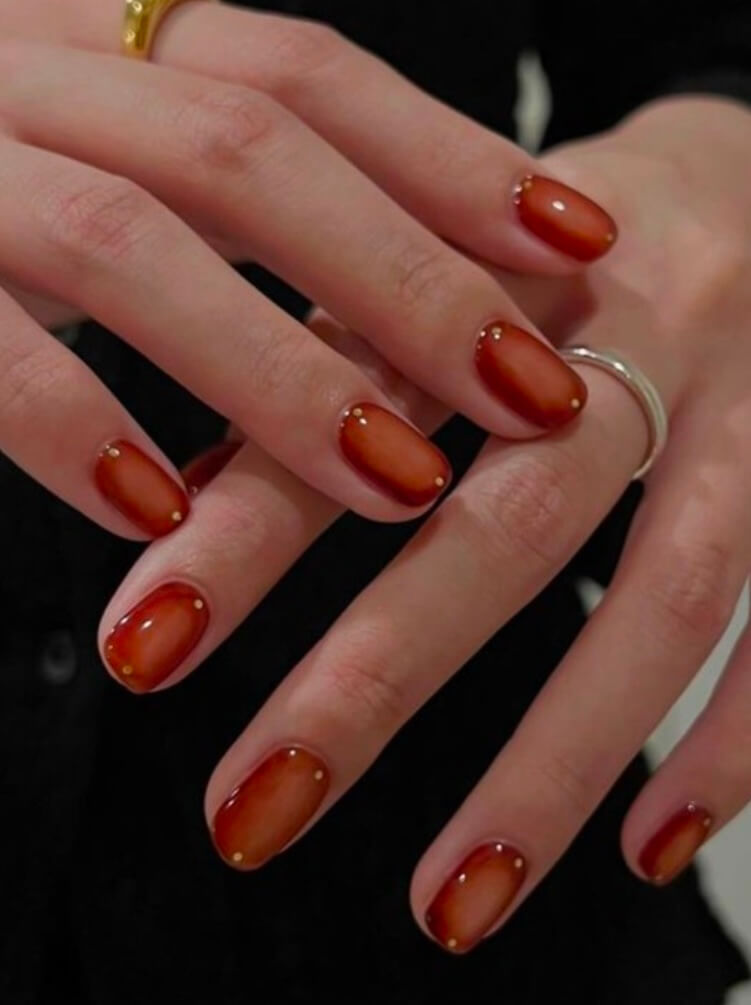 Short gel nails in burnt sienna with glossy finish