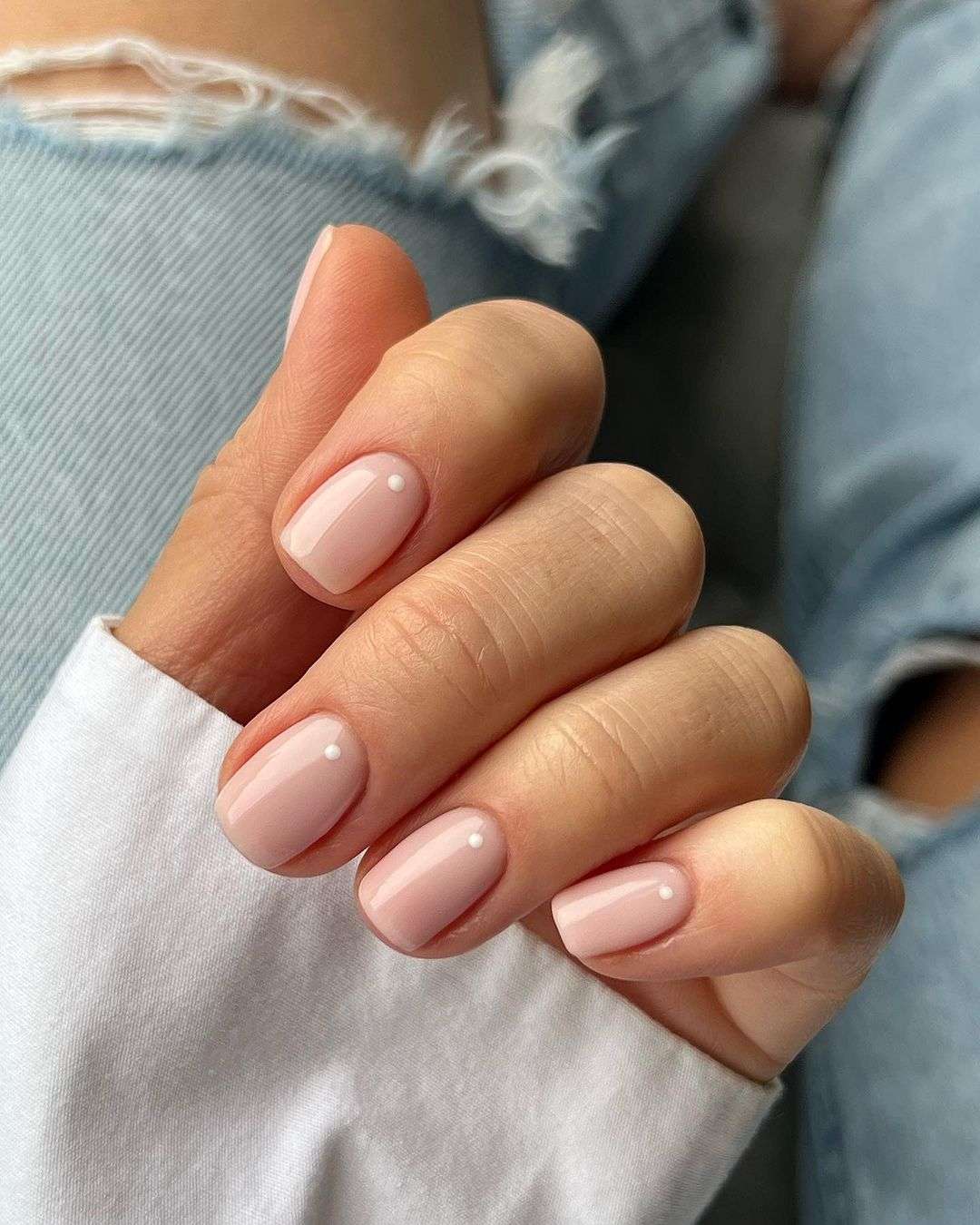 Glossy nude short gel nails with pearl accents