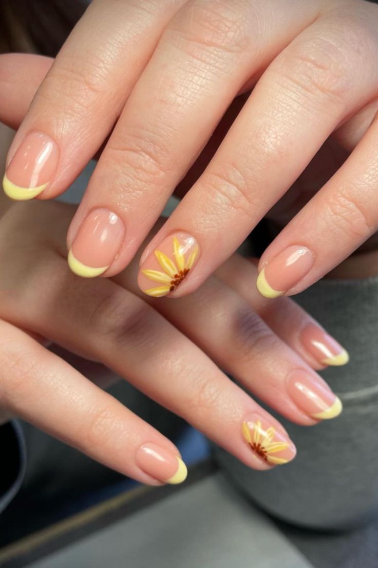 Short French gel nails with yellow floral tips on nude base