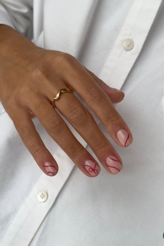 Short gel nails with red line art on nude base