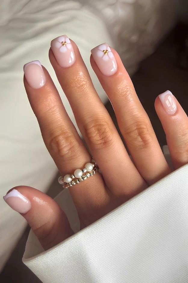 Short square nails with minimalist French tips and gold accents, Pinterest trend.